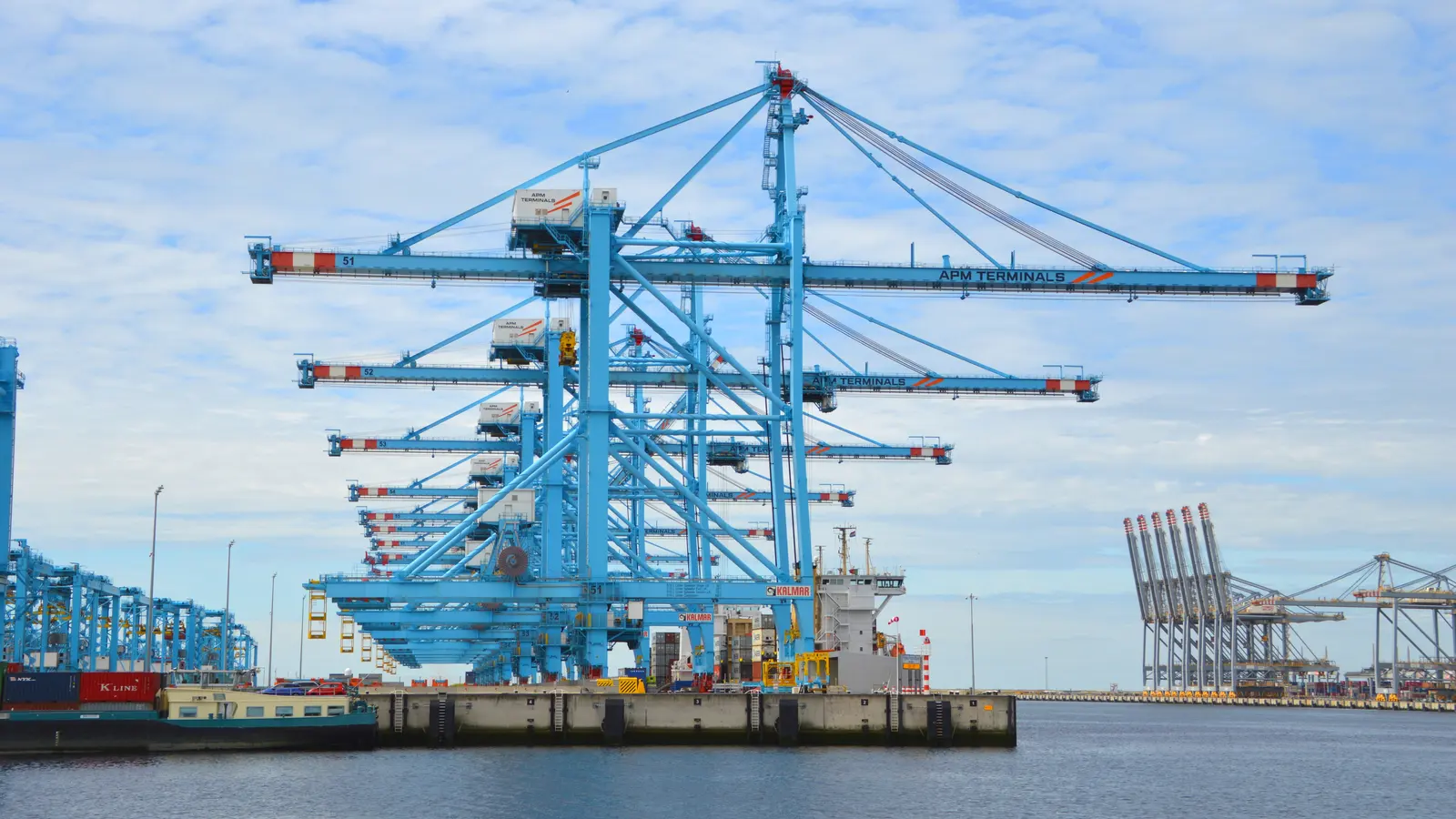 Ship-to-shore container cranes at the APM Terminals quay on the Maasvlakte in the port of Rotterdam.